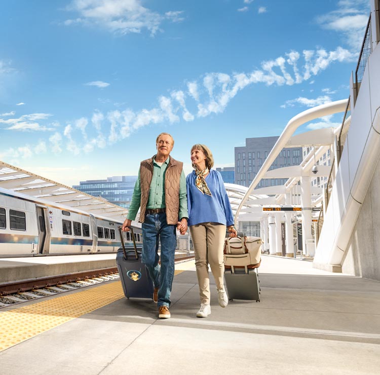 Header image of a couple walking through a station